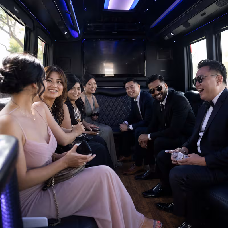 Wedding guests seated inside a Pasadena party bus
