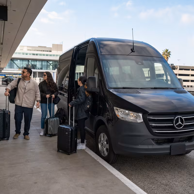 Group boarding a white charter bus for Airport Transportation transportation in Pasadena