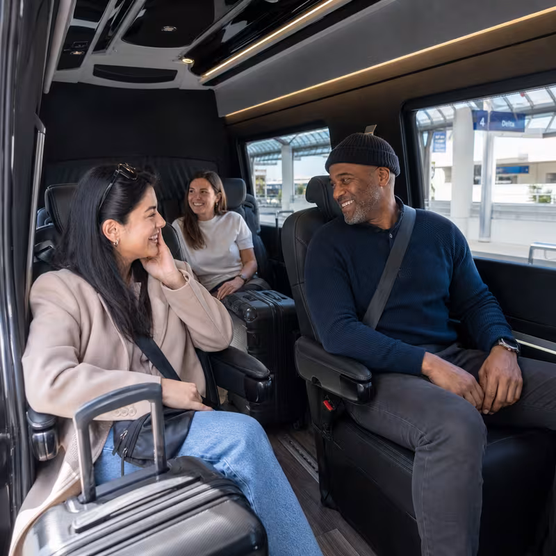 Passengers loading luggage while boarding an Pasadena group shuttle