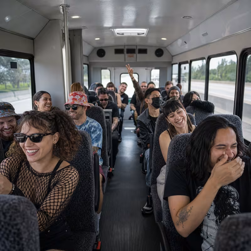 Party bus interior with wraparound leather seating and LED lighting in Pasadena