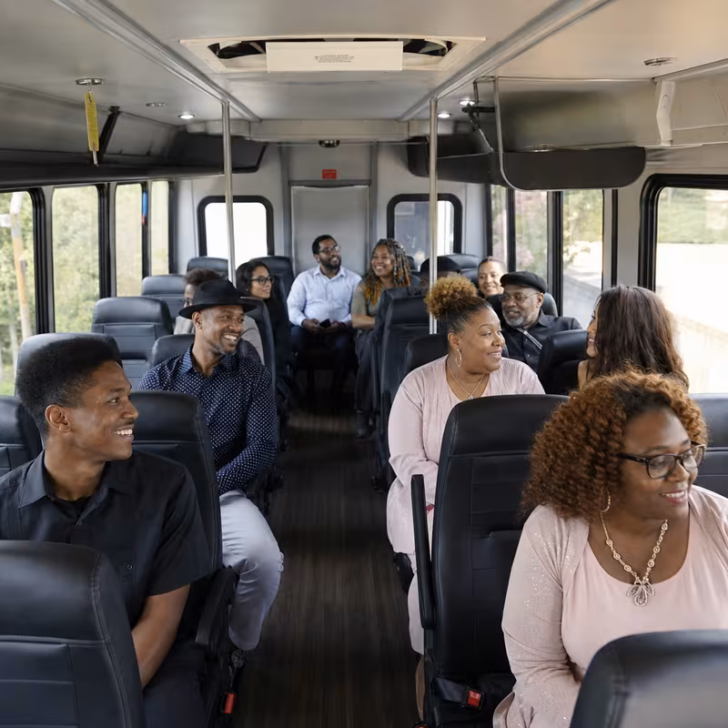 Group boarding a white charter bus for Private Event Transportation transportation in Pasadena