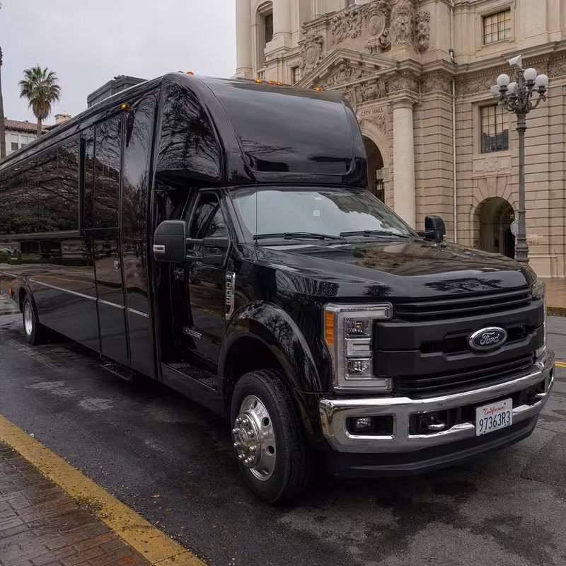 Party bus interior with wraparound leather seating and LED lighting in Pasadena