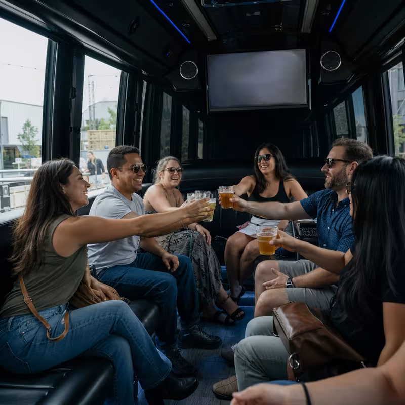 Group boarding a white charter bus for Winery & Brewery Tour Transportation transportation in Pasadena